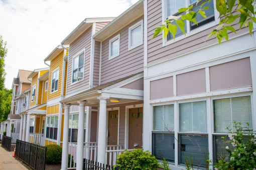 a row of townhomes with gray and yellow siding