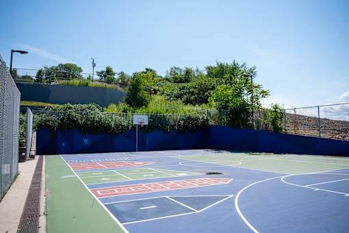 A basketball court with a blue and green surface and white lines.