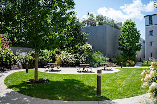 A park with a picnic table and benches.