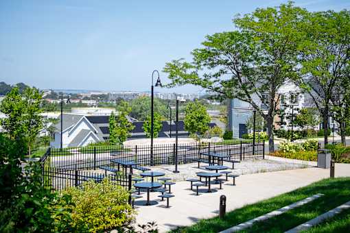 A park with picnic tables and a fence.