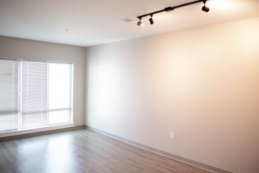 A room with a window and a light on the ceiling.