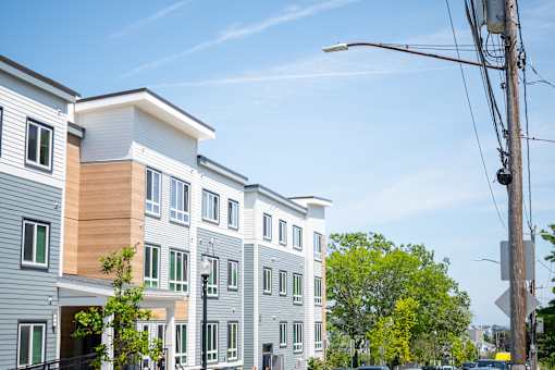 A street view of a residential area with apartment buildings.