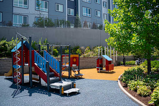 A playground with a slide, swings, and a climbing frame.