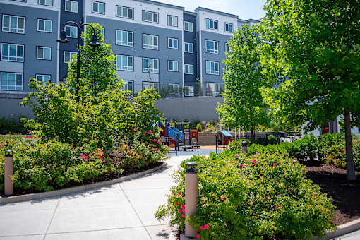 A view of a building with a playground in front of it.