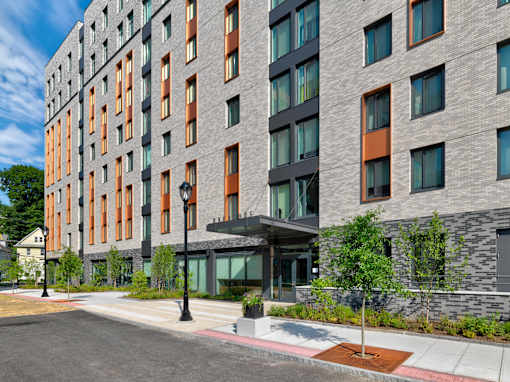 A modern building with a grey and orange facade.