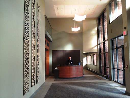 A reception area with a man standing behind the desk.