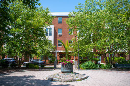 a large brick building with a large planter in front of it