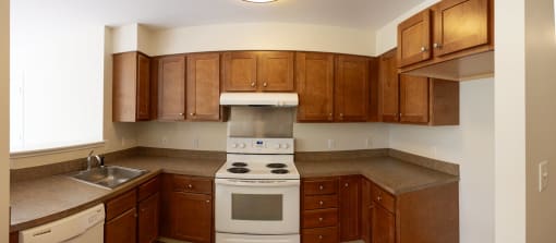 a kitchen with wooden cabinets and white appliances