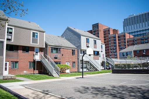 an empty parking lot in front of a row of town houses