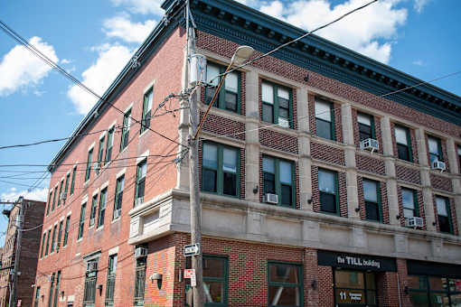 The Till Building is a red brick building with many windows.