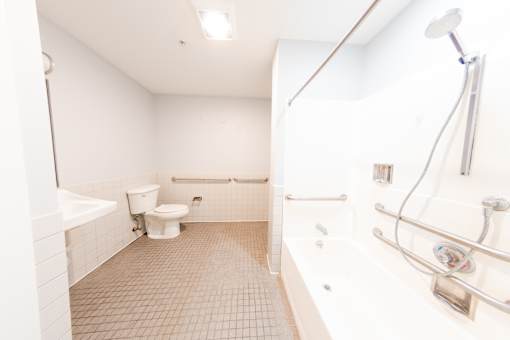 A white bathroom with a toilet, sink, and bathtub.