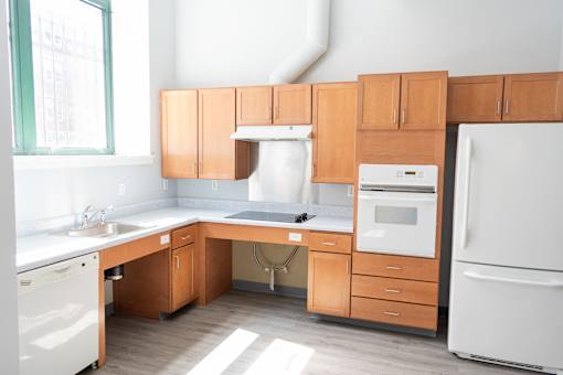 A kitchen with wooden cabinets and white appliances.