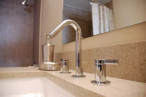 A bathroom sink with a chrome faucet and a soap holder.