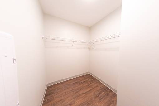 A small room with a wooden floor and white walls.