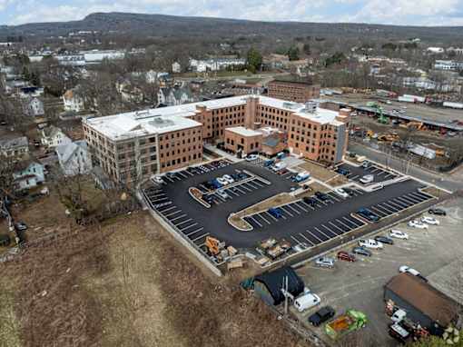 A large building with a parking lot in front of it.