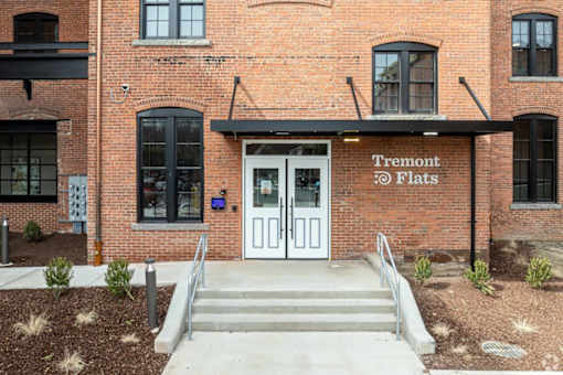 The front of a building with a sign that says Tremont @ Flats.