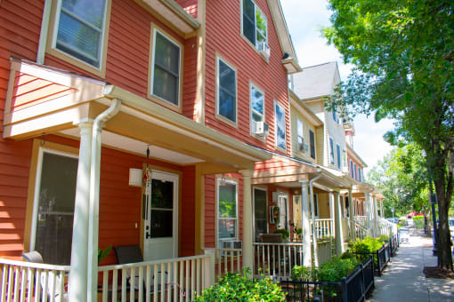 a row of red houses with white porches