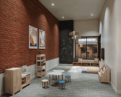 A room with a red brick wall and a black chalkboard with a white bench and a table.