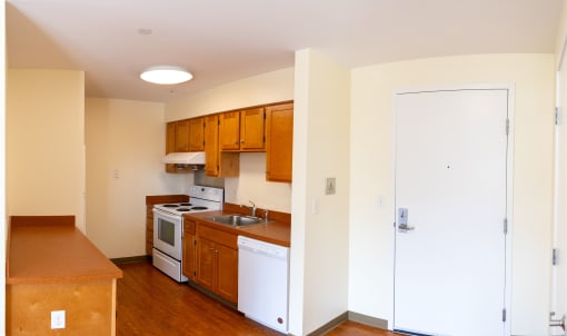 a kitchen with white appliances and wooden cabinets