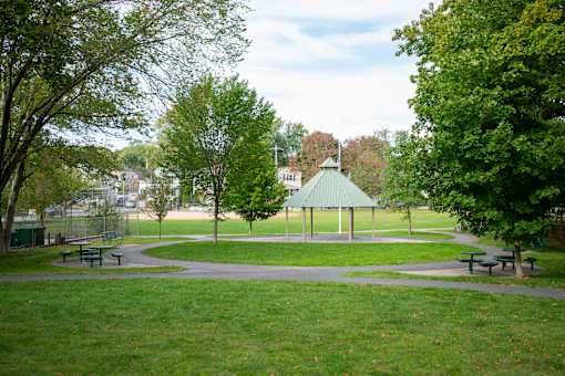 A park with a gazebo and benches.