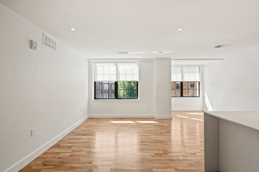 a living room with white walls and a window