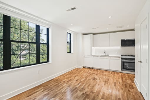 living room with a kitchen and a large window