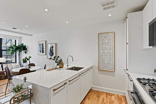 A modern kitchen with white cabinets and a large island.