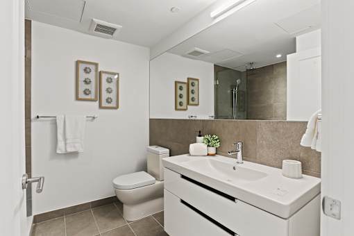luxury bathroom with a sink, toilet and shower