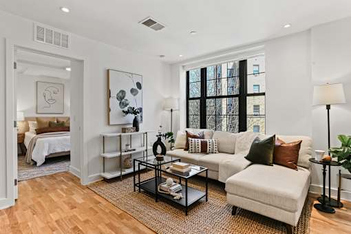 A living room with a white couch and a coffee table.