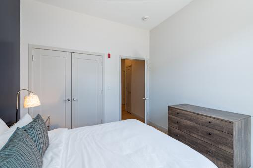 a bedroom with a bed and a dresser