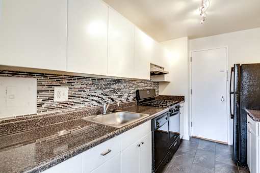 renovated kitchen with white cabinets