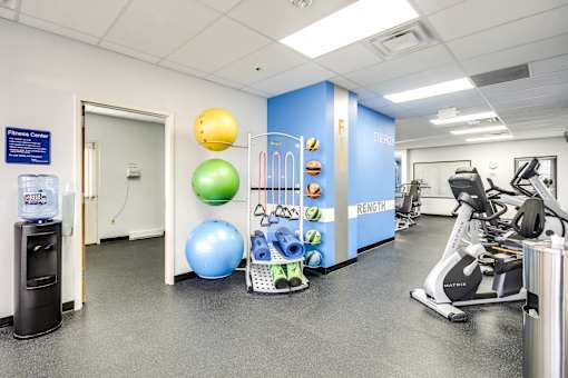 fitness center with exercise equipment and weights