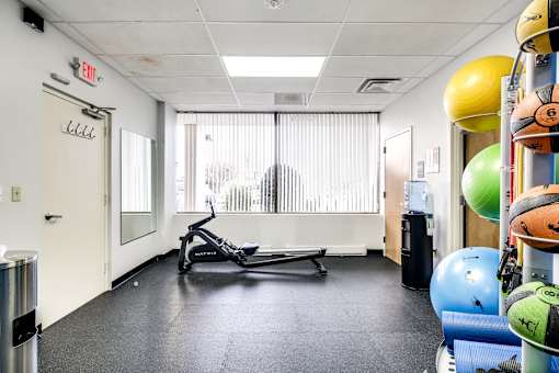fitness center with exercise equipment and weights