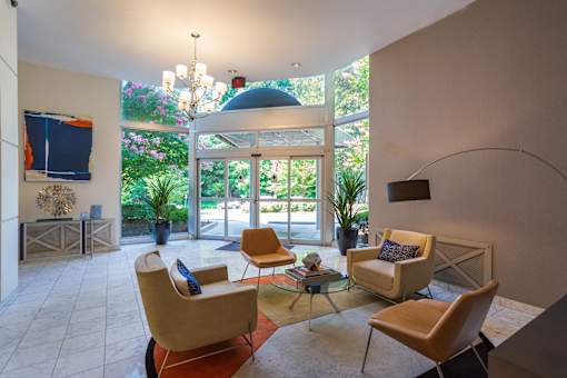 A living room with a glass table and chairs.