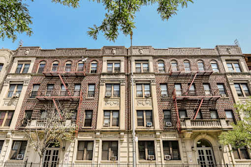 A large, old building with many windows and fire escapes.