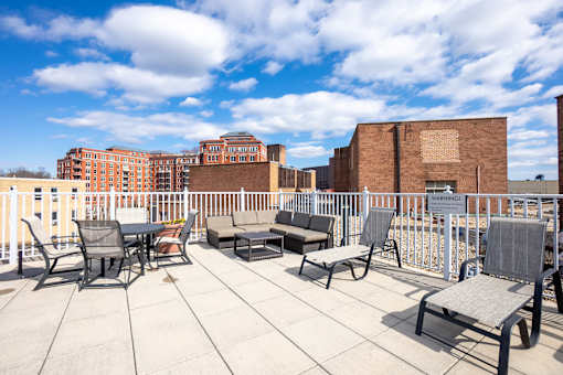A patio with chairs and a table is set up on a rooftop.