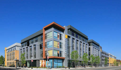 a rendering of an apartment building with a blue sky in the background
