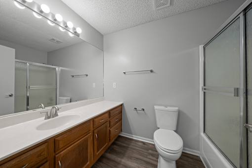 A white toilet sits next to a sink in a bathroom.