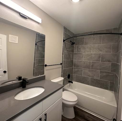 A bathroom with a white toilet and a white sink.