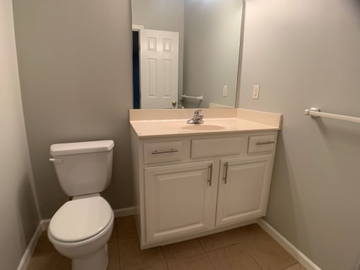 Half bathroom with large vanity in basement