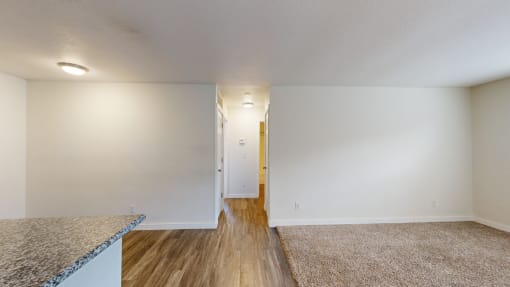 a living room with white walls and hardwood floors at Bennett Ridge Apartments, Oklahoma City, Oklahoma