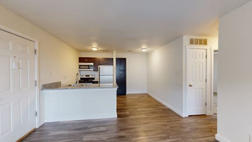 a kitchen and living room with white walls and wood floors at Bennett Ridge Apartments, Oklahoma City, 73132