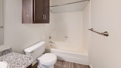 a bathroom with a toilet and a bathtub at Bennett Ridge Apartments, Oklahoma City, OK