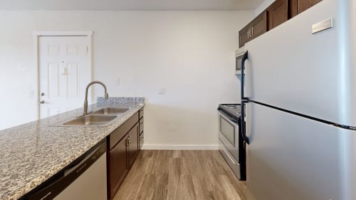 a kitchen with granite countertops and stainless steel appliances at Bennett Ridge Apartments, Oklahoma City, 73132