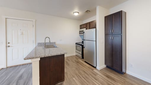 a kitchen with stainless steel appliances and a granite counter top at Bennett Ridge Apartments, Oklahoma City, OK