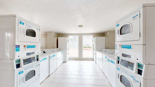 a laundry room with white washers and dryers at Bennett Ridge Apartments, Oklahoma City, 73132