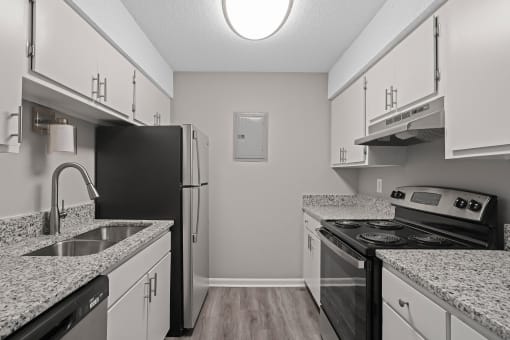 apartment kitchen with granite counter tops and black appliances