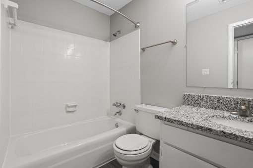 a bathroom with a tub and a sink and a toilet