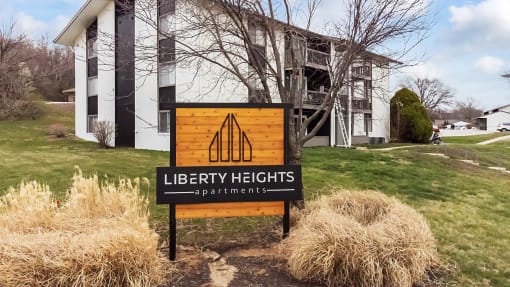 a sign in front of a library heights apartments building