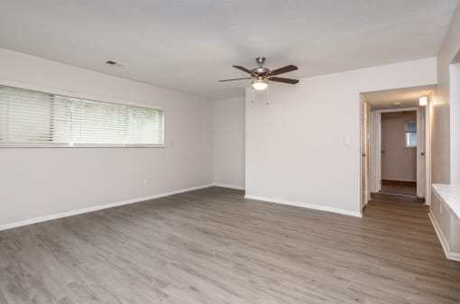 a bedroom with hardwood floors and a ceiling fan